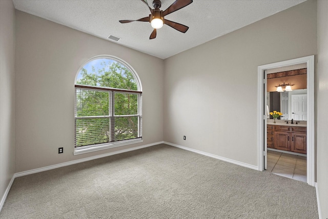 820 Windlake Cir, Heath, TX 75032 - carpeted spare room featuring ceiling fan, baseboards, a textured ceiling, and a sink