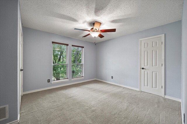 820 Windlake Cir, Heath, TX 75032 - spare room featuring a ceiling fan, carpet, a textured ceiling, and baseboards