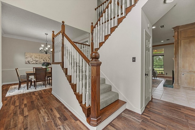 820 Windlake Cir, Heath, TX 75032 - staircase featuring ornamental molding, wood finished floors, a chandelier, and baseboards
