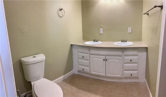 302 W Dexter St, Sherman, TX 75092 - bathroom with toilet, double vanity, tile patterned floors, and baseboards