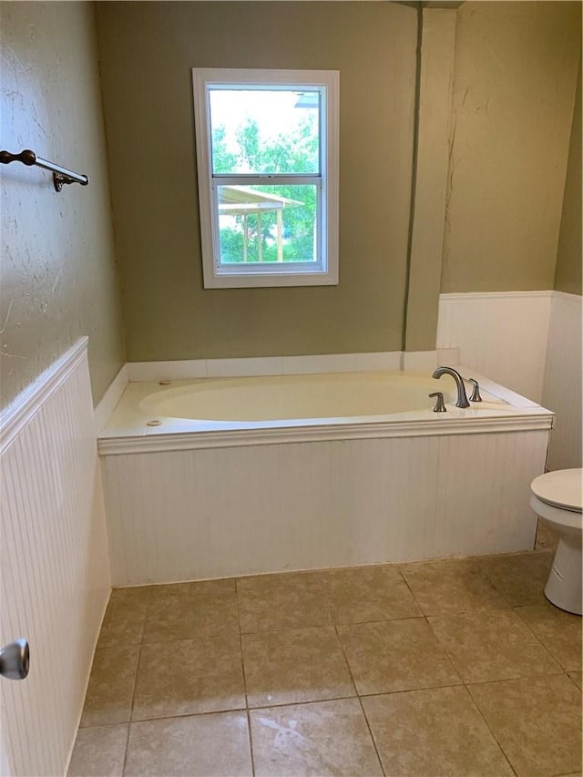 302 W Dexter St, Sherman, TX 75092 - full bath with a bath, toilet, tile patterned flooring, and wainscoting