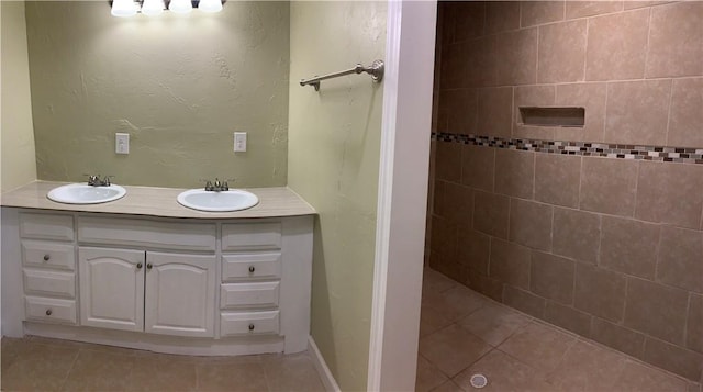 302 W Dexter St, Sherman, TX 75092 - bathroom featuring double vanity, tile patterned flooring, and tiled shower