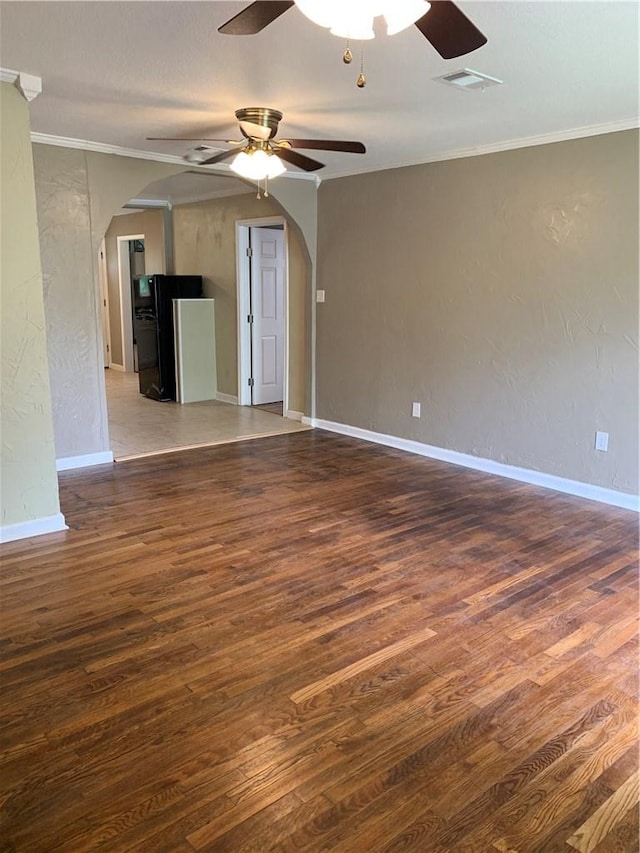 302 W Dexter St, Sherman, TX 75092 - unfurnished living room featuring arched walkways, wood finished floors, ceiling fan, ornamental molding, and a textured wall