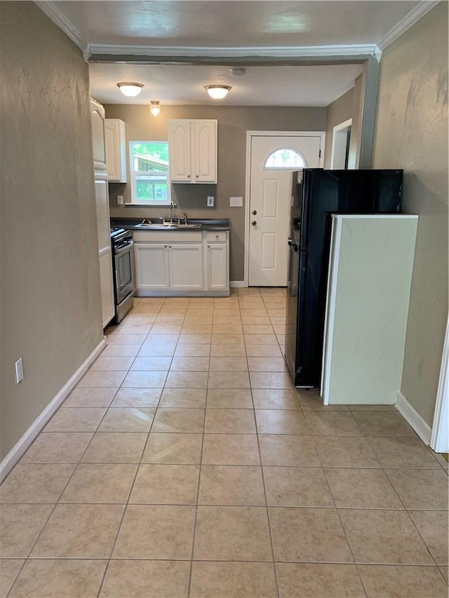 302 W Dexter St, Sherman, TX 75092 - kitchen featuring gas stove, a sink, white cabinets, crown molding, and light tile patterned floors