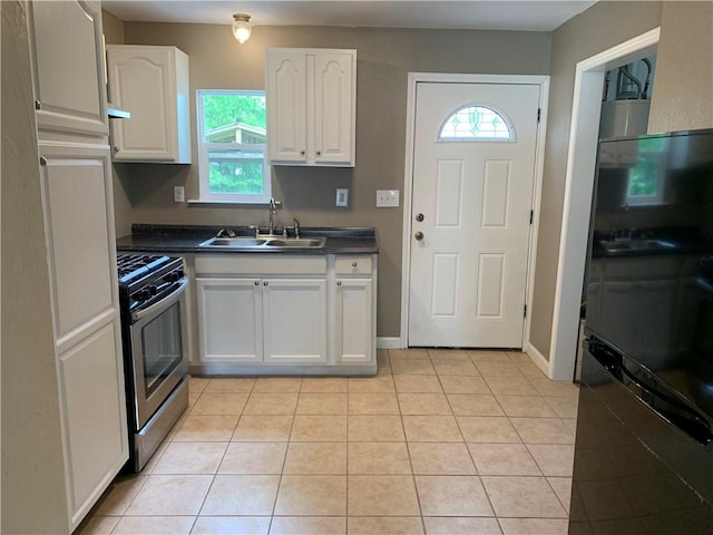 302 W Dexter St, Sherman, TX 75092 - kitchen with stainless steel range with gas stovetop, a sink, dark countertops, and plenty of natural light