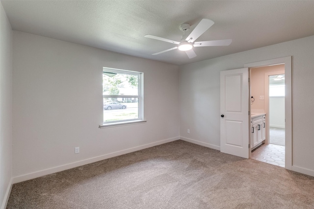 10240 Carry Back Cir, Dallas, TX 75229 - spare room featuring light colored carpet, a ceiling fan, and baseboards