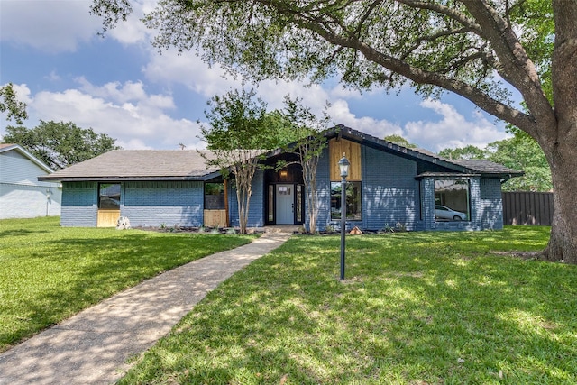 10240 Carry Back Cir, Dallas, TX 75229 - mid-century inspired home featuring brick siding and a front lawn