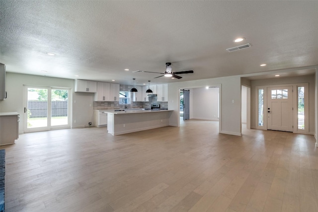 10240 Carry Back Cir, Dallas, TX 75229 - living area featuring recessed lighting, ceiling fan, a textured ceiling, baseboards, and light wood finished floors