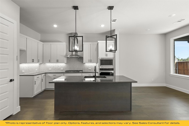802 Marathon Ct, Rockwall, TX 75087 - kitchen featuring stainless steel appliances, a sink, wall chimney exhaust hood, decorative backsplash, and dark wood-style flooring