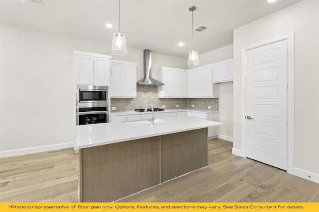 802 Marathon Ct, Rockwall, TX 75087 - kitchen featuring stainless steel appliances, wall chimney exhaust hood, backsplash, light wood finished floors, and recessed lighting