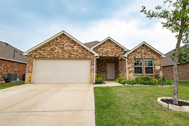 1003 Dewy Glen Ln, Princeton, TX 75407 - view of front of home with a garage, a front yard, concrete driveway, brick siding, and central air condition unit