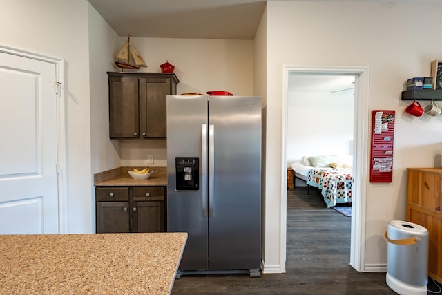 1003 Dewy Glen Ln, Princeton, TX 75407 - kitchen with stainless steel refrigerator with ice dispenser, dark wood-style flooring, dark brown cabinets, and light stone countertops