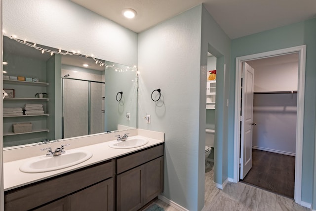 1003 Dewy Glen Ln, Princeton, TX 75407 - bathroom with a spacious closet, a shower stall, double vanity, and toilet