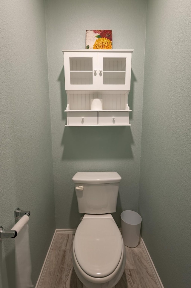 1003 Dewy Glen Ln, Princeton, TX 75407 - bathroom with wood finished floors, baseboards, and toilet