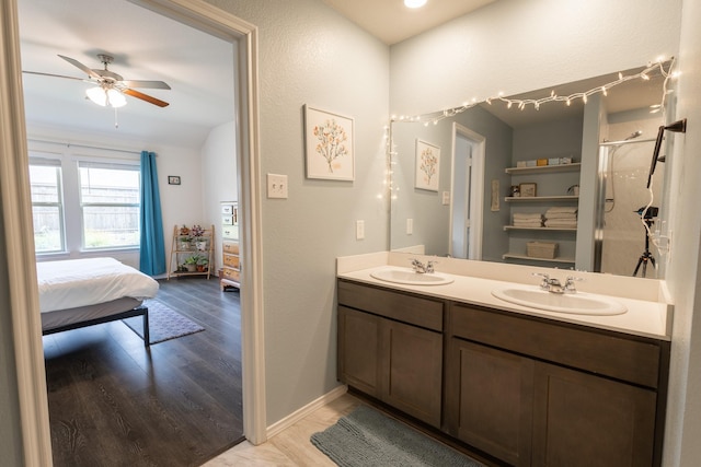 1003 Dewy Glen Ln, Princeton, TX 75407 - bathroom featuring double vanity, wood finished floors, ceiling fan, and a shower