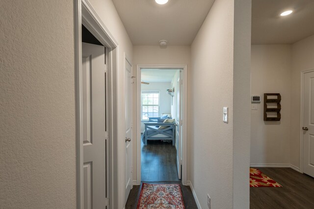 1003 Dewy Glen Ln, Princeton, TX 75407 - hallway with dark wood finished floors, a textured wall, and baseboards