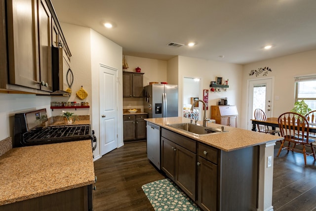 1003 Dewy Glen Ln, Princeton, TX 75407 - kitchen with appliances with stainless steel finishes, dark wood-style flooring, a center island with sink, recessed lighting, and dark brown cabinetry