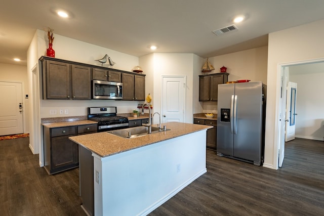 1003 Dewy Glen Ln, Princeton, TX 75407 - kitchen with stainless steel appliances, dark brown cabinetry, dark wood finished floors, a center island with sink, and recessed lighting