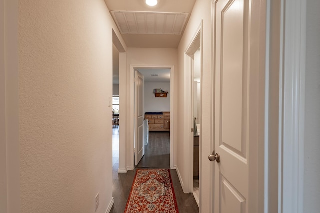 1003 Dewy Glen Ln, Princeton, TX 75407 - hall with dark wood finished floors, a textured wall, and baseboards