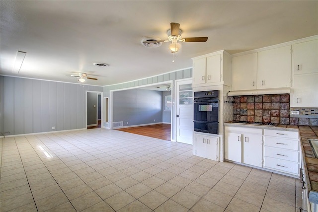 508 Ward St, Winnsboro, TX 75494 - kitchen with black oven, a ceiling fan, a warming drawer, and decorative backsplash