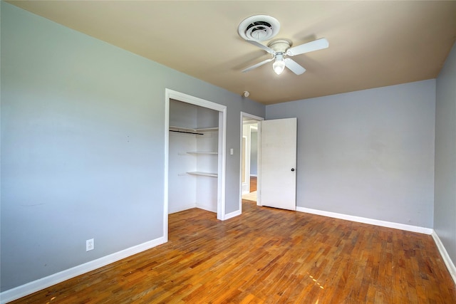 508 Ward St, Winnsboro, TX 75494 - unfurnished bedroom featuring baseboards, a closet, wood finished floors, and a ceiling fan