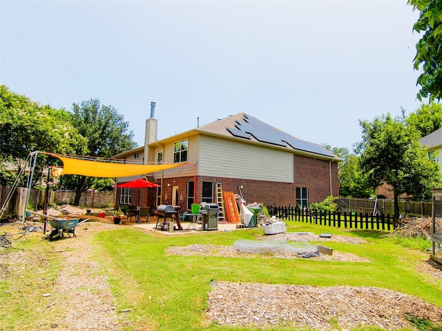 6 Altman Ct, Mansfield, TX 76063 - rear view of house featuring brick siding, solar panels, a chimney, and a patio