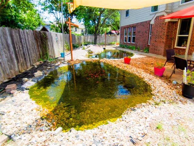 6 Altman Ct, Mansfield, TX 76063 - fenced backyard with a small pond