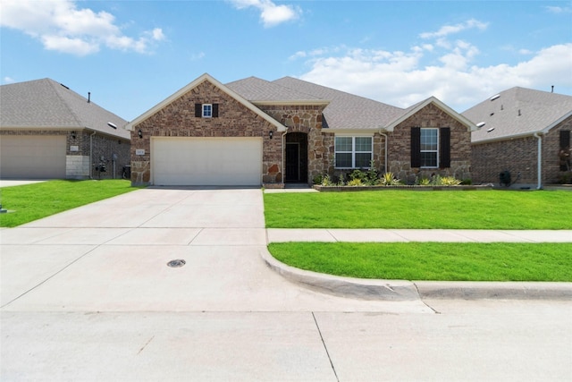 1424 Millican Ln, Aubrey, TX 76227 - view of front facade featuring a garage, driveway, a front lawn, stone siding, and roof with shingles