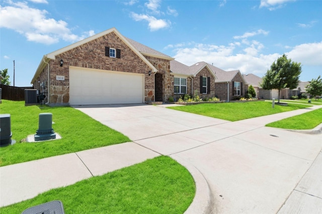 1424 Millican Ln, Aubrey, TX 76227 - single story home featuring an attached garage, concrete driveway, brick siding, cooling unit, and stone siding