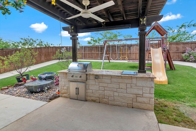 3113 Sangria Ln, Fort Worth, TX 76177 - fenced backyard featuring exterior kitchen, a playground, ceiling fan, and a patio