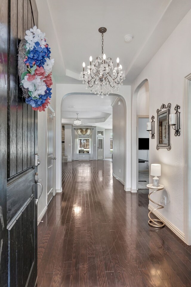 3113 Sangria Ln, Fort Worth, TX 76177 - entryway featuring arched walkways, hardwood / wood-style flooring, a chandelier, and a raised ceiling