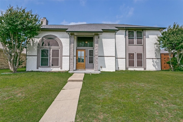 4223 Wild Plum Dr, Carrollton, TX 75010 - view of front of house with brick siding, a front lawn, a chimney, and roof with shingles