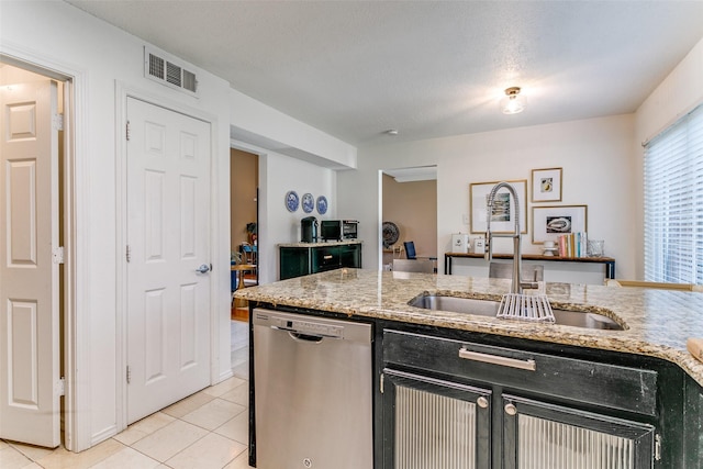 4223 Wild Plum Dr, Carrollton, TX 75010 - kitchen with stainless steel dishwasher, a sink, light tile patterned flooring, light stone counters, and dark cabinetry