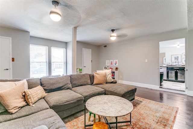 4223 Wild Plum Dr, Carrollton, TX 75010 - living room featuring a textured ceiling, light wood finished floors, baseboards, and a ceiling fan