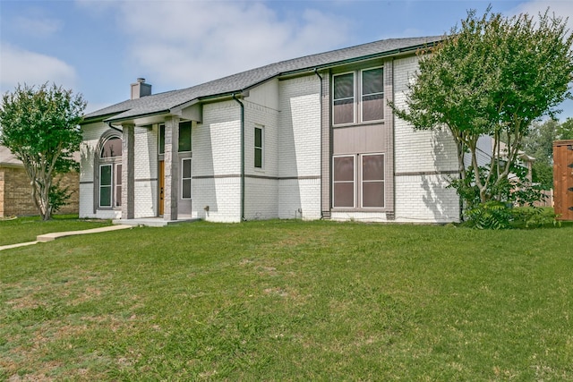 4223 Wild Plum Dr, Carrollton, TX 75010 - view of front of house featuring brick siding, a chimney, and a front lawn