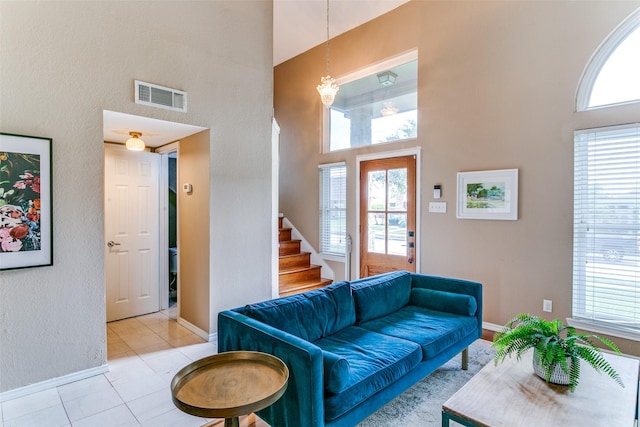 4223 Wild Plum Dr, Carrollton, TX 75010 - living room with a high ceiling, stairway, light tile patterned floors, and baseboards