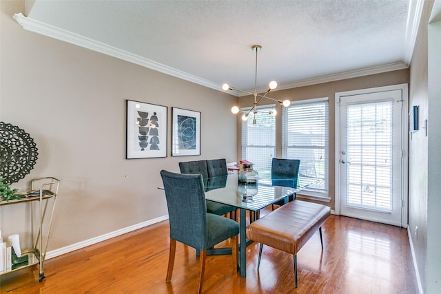 4223 Wild Plum Dr, Carrollton, TX 75010 - dining room featuring ornamental molding, a chandelier, wood finished floors, plenty of natural light, and baseboards
