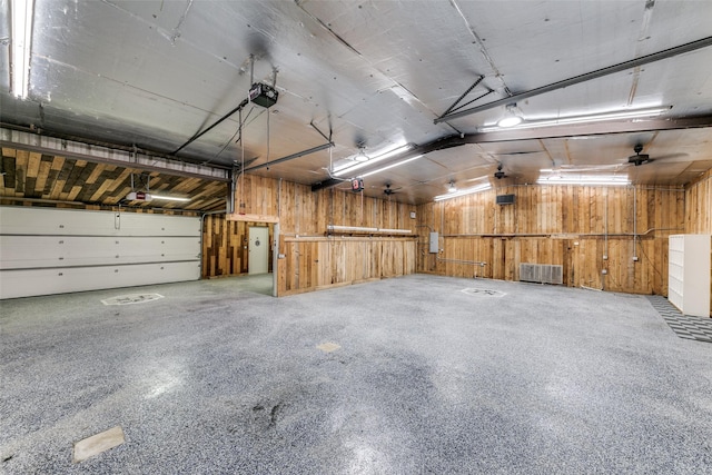 13914 Overlook Ln, Forney, TX 75126 - garage featuring wood walls and a garage door opener