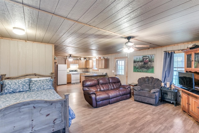 13914 Overlook Ln, Forney, TX 75126 - bedroom featuring freestanding refrigerator, light wood finished floors, multiple windows, wooden walls, and wooden ceiling