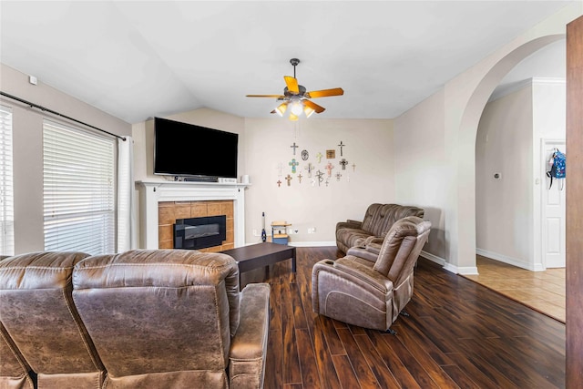 5608 Aberdeen Ct, Temple, TX 76502 - living area featuring ceiling fan, arched walkways, a tiled fireplace, wood finished floors, and baseboards
