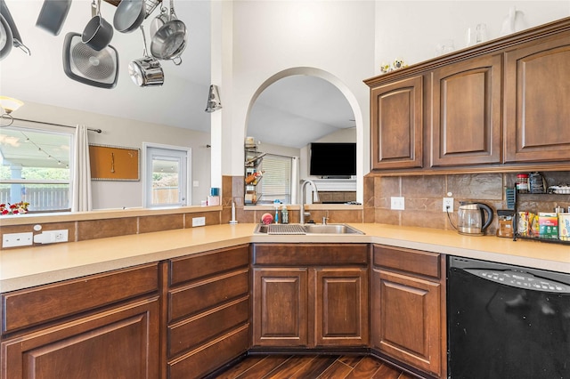 5608 Aberdeen Ct, Temple, TX 76502 - kitchen featuring black dishwasher, a sink, dark wood-style floors, light countertops, and vaulted ceiling