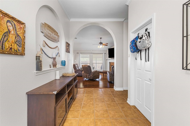 5608 Aberdeen Ct, Temple, TX 76502 - corridor with crown molding, arched walkways, and light tile patterned floors