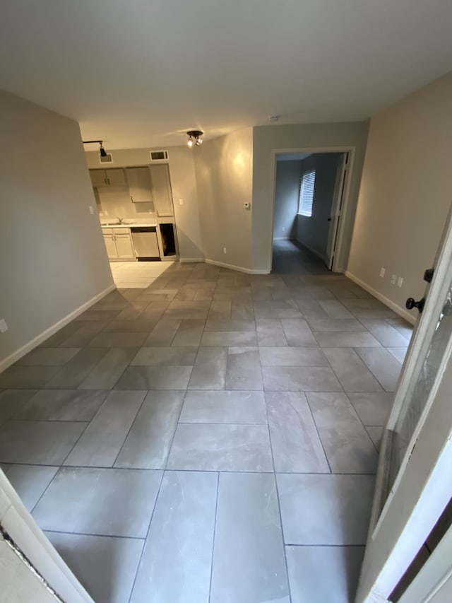 9823 Walnut St Unit L112, Dallas, TX 75243 - unfurnished living room with baseboards and light tile patterned floors