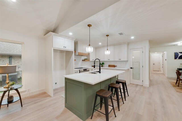 3605 Jomar Dr, Plano, TX 75075 - kitchen with white cabinetry, decorative backsplash, a sink, light wood-style flooring, and recessed lighting
