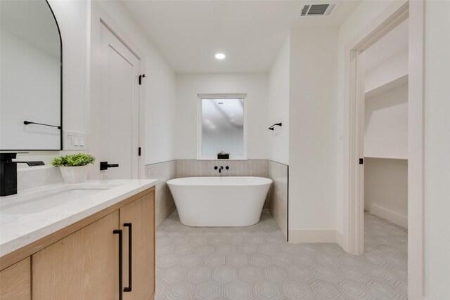 3605 Jomar Dr, Plano, TX 75075 - bathroom with wainscoting, vanity, and a freestanding bath