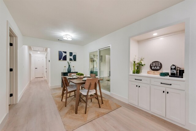 3605 Jomar Dr, Plano, TX 75075 - dining area featuring attic access, light wood finished floors, and baseboards