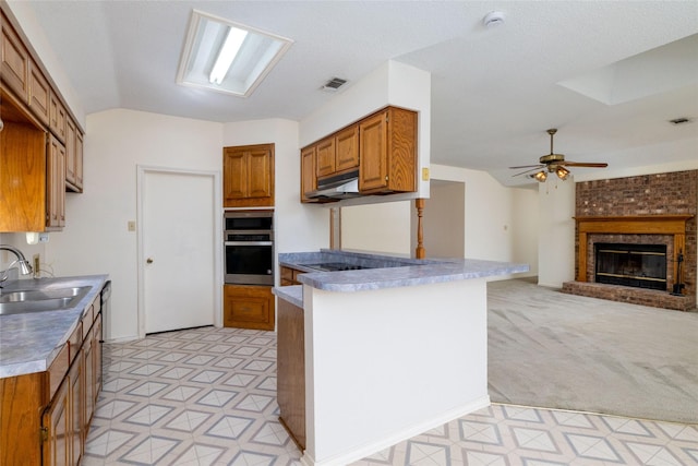 4007 Cherokee Ct, Granbury, TX 76048 - kitchen featuring a sink, stainless steel oven, light floors, brown cabinets, and vaulted ceiling