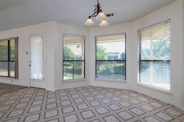 4007 Cherokee Ct, Granbury, TX 76048 - unfurnished dining area featuring a chandelier