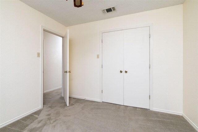 4007 Cherokee Ct, Granbury, TX 76048 - unfurnished bedroom featuring light carpet, a closet, baseboards, and a ceiling fan