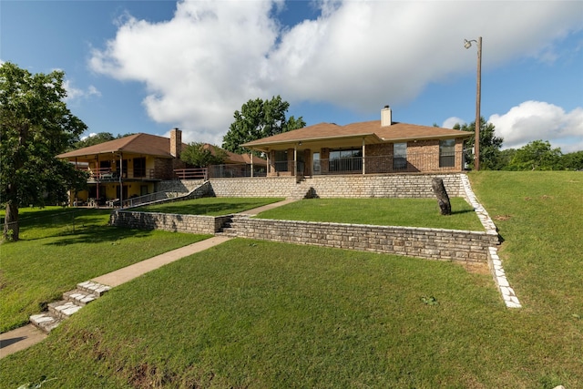 4007 Cherokee Ct, Granbury, TX 76048 - rear view of property with a lawn, a chimney, and brick siding